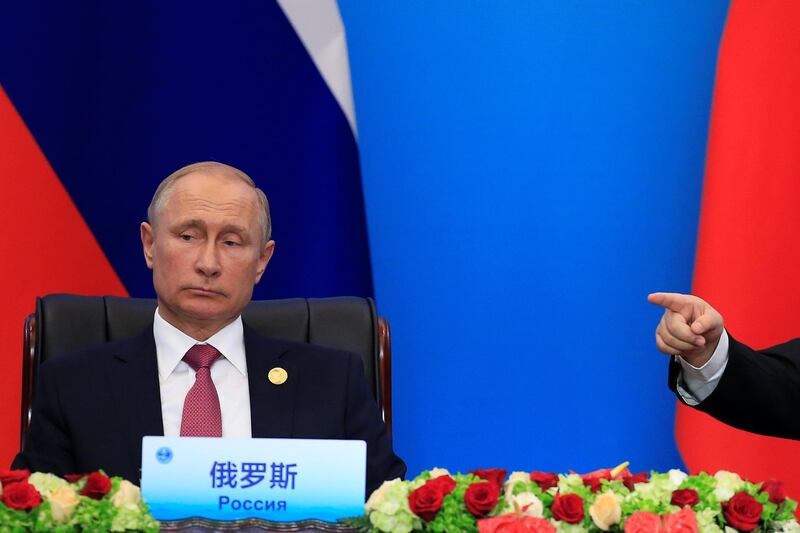 Russia's President Vladimir Putin looks on as China's President Xi Jinping points during Shanghai Cooperation Organization (SCO) summit in Qingdao, Shandong Province, China June 10, 2018. REUTERS/Aly Song