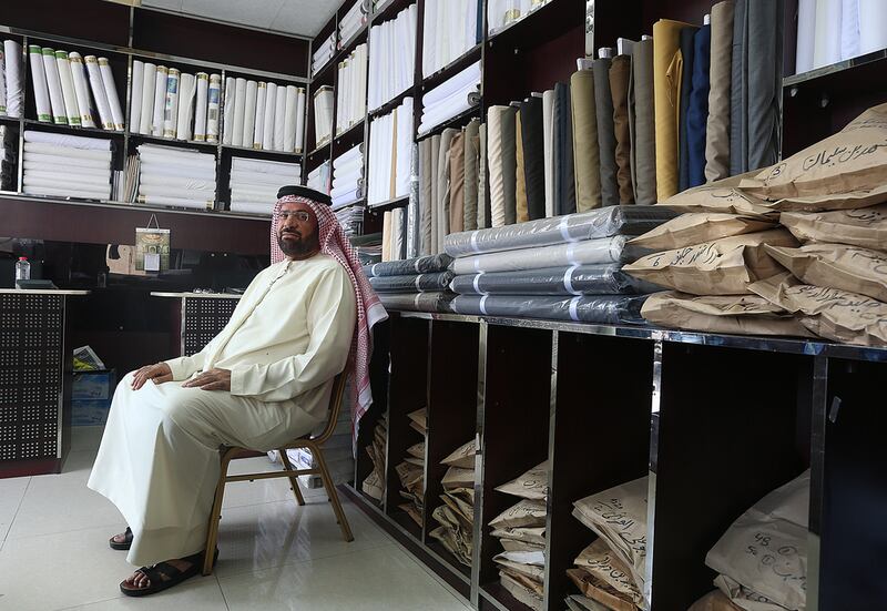 Mohammed Al Madani developed a passion for tailoring from his father when he was allowed to work for the family business and has since expanded National Tailors across the Emirates. Satish Kumar / The National