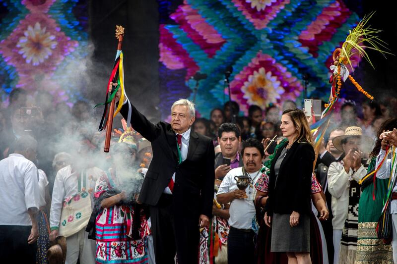 Andres Manuel Lopez Obrador holds up a ceremonial wooden staff during the 58th presidential inauguration event at the central plaza, known as the Zocalo, in Mexico City. Bloomberg