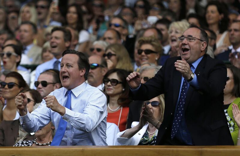British Prime Minister David Cameron (L) and Scotland's First Minister Alex Salmond (R) celebrate as Britain's Andy Murray beats Serbia's Novak Djokovic in the men's singles final on day thirteen of the 2013 Wimbledon Championships tennis tournament at the All England Club in Wimbledon, southwest London, on July 7, 2013. Murray won 6-4, 7-5, 6-4. AFP PHOTO / POOL / ANJA NIEDRINGHAUS  - RESTRICTED TO EDITORIAL USE
 *** Local Caption ***  509227-01-08.jpg