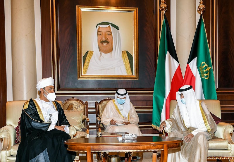 A handout picture released by the press office of the Emir of Kuwait Diwan on October 1, 2020 shows Oman's Sultan Haitham bin Tariq al-Said (L) meeting with Kuwait's new Emir Sheikh Nawaf al-Ahmad al-Jaber Al-Sabah (R) and offering condolences to the latter, while mask-clad due to the COVID-19 coronavirus pandemic, at the Emiri Terminal of Kuwait International Airport. (Photo by - / EMIR OF KUWAIT DIWAN / AFP) / == RESTRICTED TO EDITORIAL USE - MANDATORY CREDIT "AFP PHOTO / HO / EMIR OF KUWAIT DIWAN" - NO MARKETING NO ADVERTISING CAMPAIGNS - DISTRIBUTED AS A SERVICE TO CLIENTS ==
