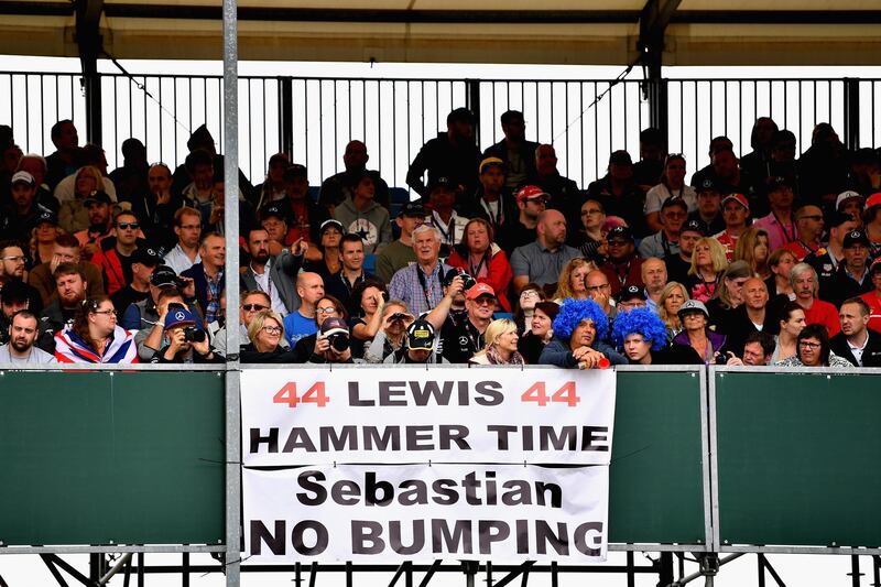 NORTHAMPTON, ENGLAND - JULY 16: Lewis Hamilton of Great Britain and Mercedes GP fans with a sign referencing the incident between Sebastian Vettel of Germany and Ferrari and Lewis in Baku during the Formula One Grand Prix of Great Britain at Silverstone on July 16, 2017 in Northampton, England.  (Photo by Dan Mullan/Getty Images)