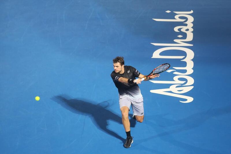 Stan Wawrinka slices a backhand back to Milos Raonic during their semi-final. Mona Al Marzooqi / The National