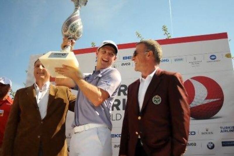 Justin Rose, centre, poses with the trophy after winning the Turkish Airlines World Golf Final by a shot over Lee Westwood.
