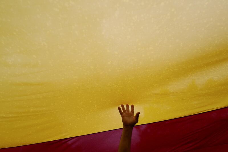 A man touches a Spanish flag during a demonstration in favour of a unified Spain a day before the banned October 1 independence referendum, in Barcelona, Spain. Susana Vera / Reuters