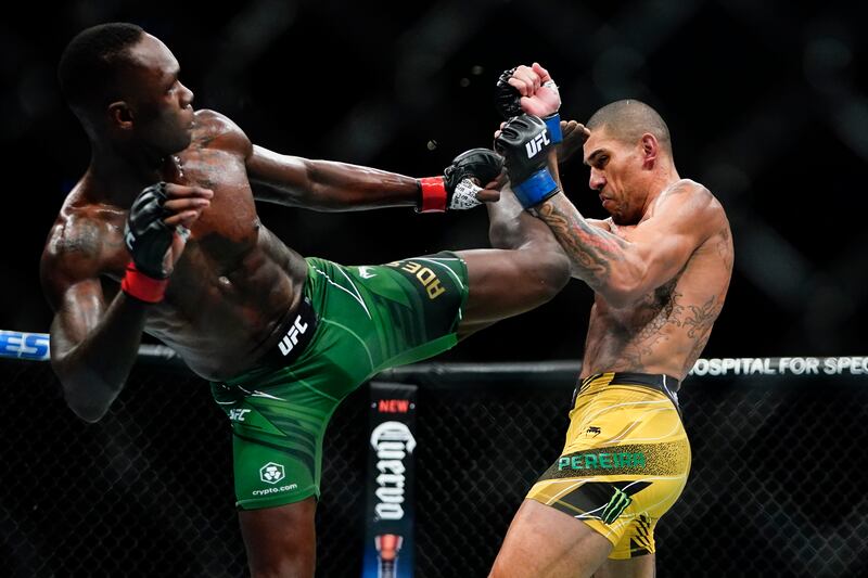 Alex Pereira blocks a kick by Israel Adesanya during the third round. AP