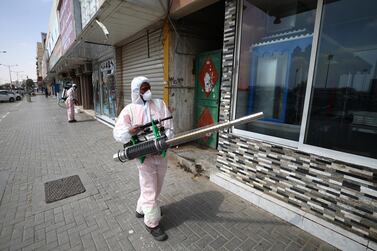 A worker sprays disinfectant, as a preventive measure against the spread of coronavirus, in Sharjah. Getty