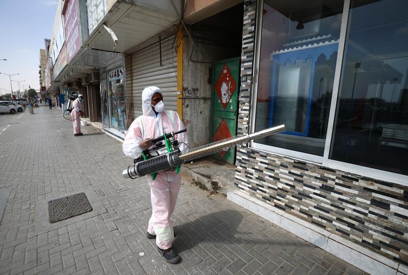 SHARJAH, UNITED ARAB EMIRATES - MARCH 25:  A worker sprays disinfectant, as a preventive measure against the spread of COVID-19 on March 25, 2020 in Sharjah, United Arab Emirates. The Coronavirus (COVID-19) pandemic has spread to at least 182 countries, claiming over 18,000 lives and infecting hundreds of thousands more. (Photo by Francois Nel/Getty Images)