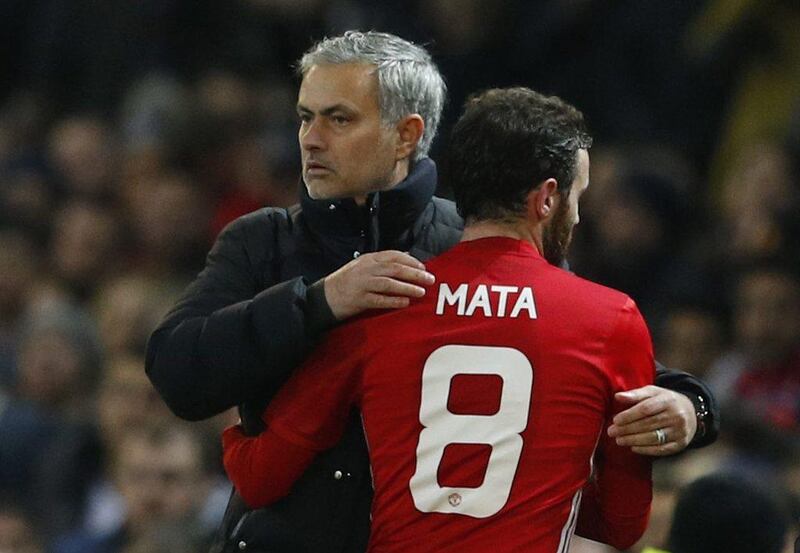 Juan Mata, right, scored the first of Manchester United's two goals against Hull City as Jose Mourinho looks to become only the third manager after Brian Clough and Alex Ferguson to win a fourth. League Cup Phil Noble / Reuters 