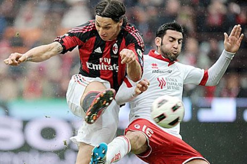Zlatan Ibrahimovic battles for the ball with Bari defender Nicola Belmonte. Daniel Dal Zennaro / EPA