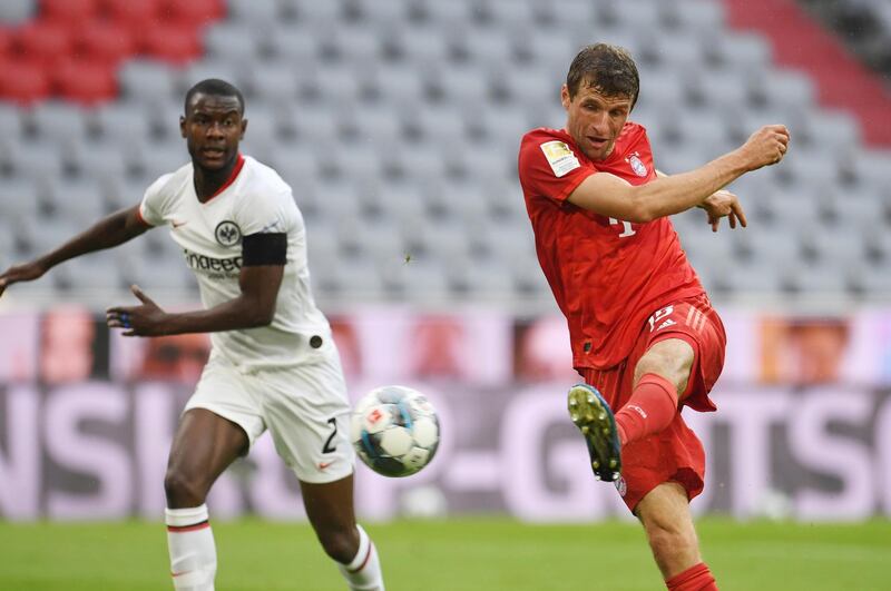 Bayern Munich's Thomas Muller scores his side's second goal during the German Bundesliga soccer match between Bayern Munich and Eintracht Frankfurt in Munich, Germany, Saturday, May 23, 2020. (Andreas Gebert/pool via AP)