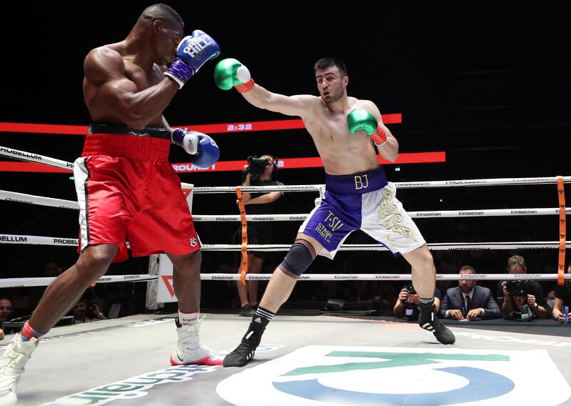 Bakhodir Jalolov (blue and white) takes on Julio Cesar Calimeno (red) in a Heavyweight bout at the Coca Cola Arena, Dubai. Chris Whiteoak/ The National