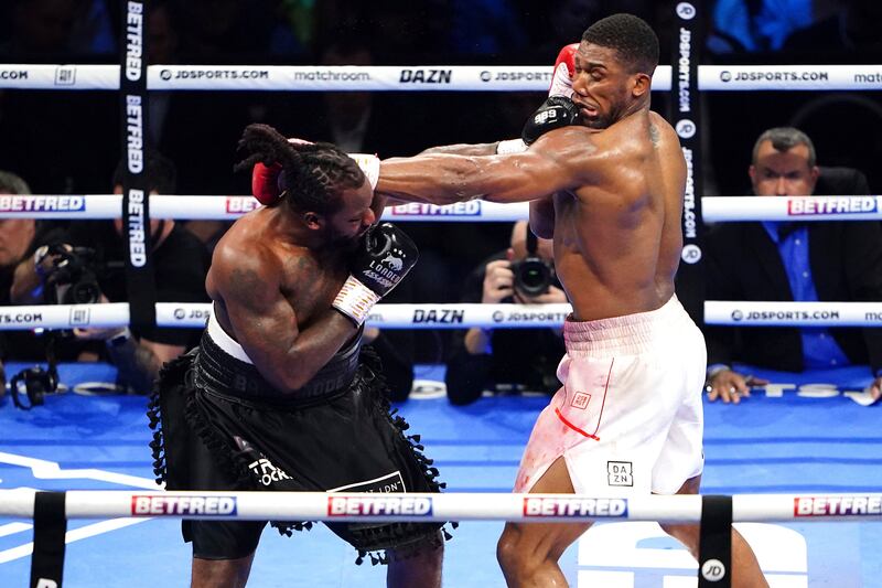Jermaine Franklin, right, punches Anthony Joshua during a heavyweight boxing match at The O2. AP