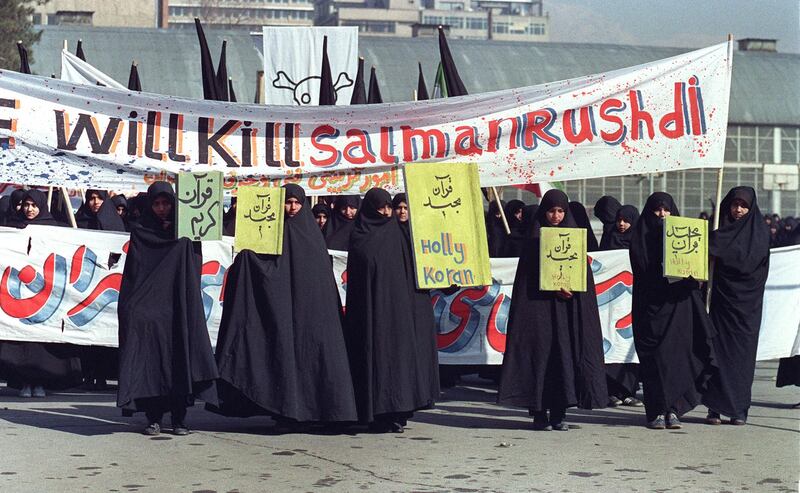Iranian women hold banners during a demonstration against Rushdie in Tehran. AFP