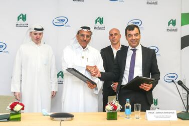 Khalaf Ahmad Al Habtoor (second from left), founding chairman of Al Habtoor Group, shaking hand with Amnon Shashua, chief executive of Mobileye, after signing the pact. Courtesy Al Habtoor Group
