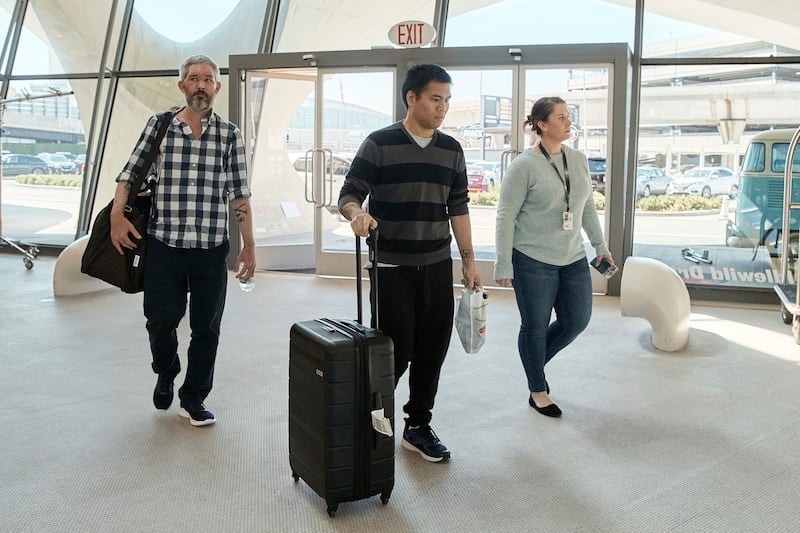 American's Andy Huynh, centre, and Alex Drueke, left, arrive at the TWA Hotel on Friday. AP