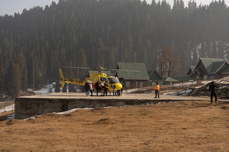 Affluent tourists take $160 helicopter rides in Gulmarg, Kashmir, as there is no snow for traditional winter sports. Wasim Nabi for The National