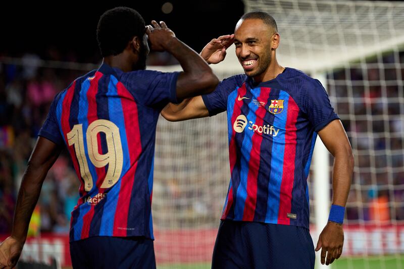 Barcelona's Pierre-Emerick Aubameyang celebrates with Franck Kessie after scoring in the friendly against Pumas UNAM at Camp Nou on Sunday, August 7, 2022. Getty