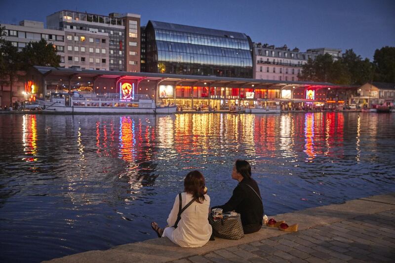 Parisians enjoy the opening night of the floating cinema on the banks of the Siene river. Getty Images