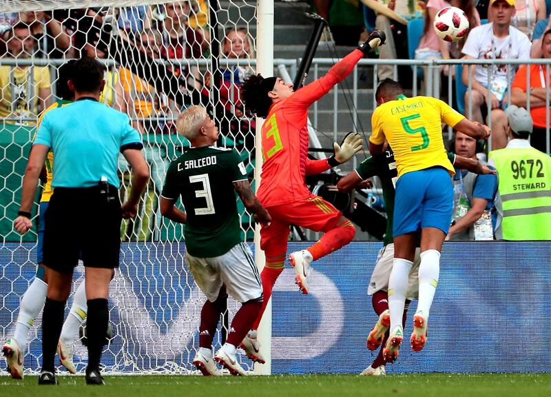 Casemiro of Brazil, right, Carlos Salcedo of Mexico, third right, and goalkeeper Guillermo Ochoa of Mexico, second right, in action. Wallace Woon / EPA