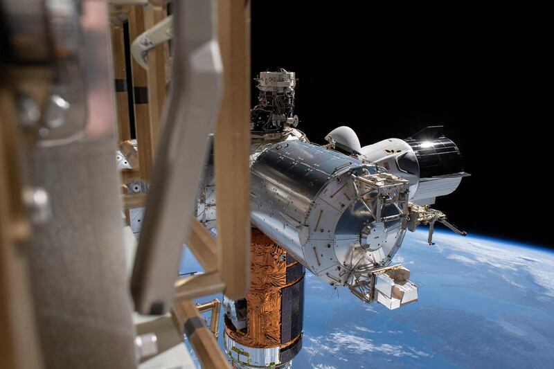 This NASA image released July 7, 2020 shows the SpaceX Crew Dragon (CenterR), the Japanese H-II Transfer Vehicle-9 resupply ship (C bottom) and Europe's Columbus laboratory module as they figure prominently in this photograph taken during a spacewalk conducted by astronauts Bob Behnken and Chris Cassidy on July 1, 2020. - All three are attached to the US Harmony module with the International Docking Adapter on top. (Photo by Handout / NASA / AFP) / RESTRICTED TO EDITORIAL USE - MANDATORY CREDIT "AFP PHOTO /NASA/HANDOUT " - NO MARKETING - NO ADVERTISING CAMPAIGNS - DISTRIBUTED AS A SERVICE TO CLIENTS