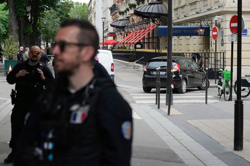 Police officers guard the Harry Winston jewellery shop in Paris, after a robbery. AP