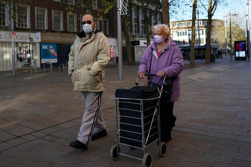 A couple wearing face masks walk through Hull city centre. Getty Images