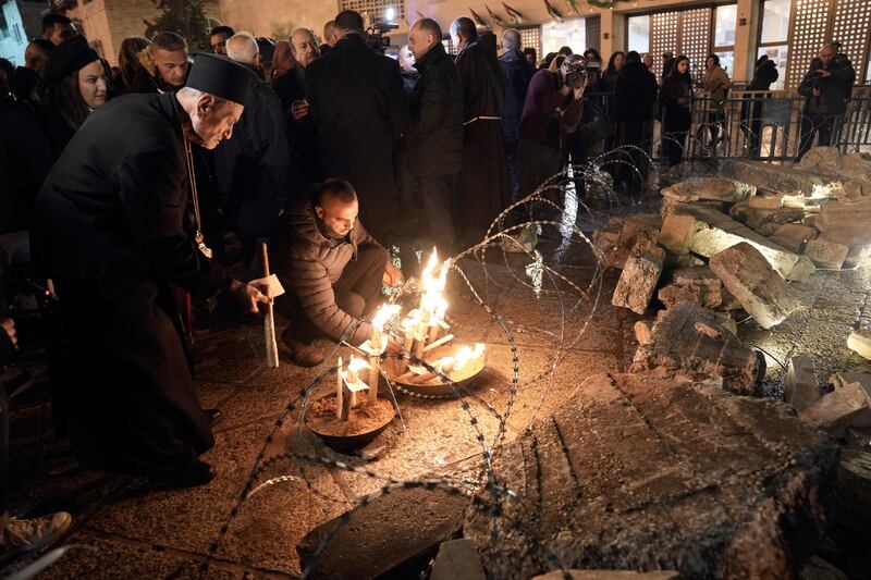 Candles are lit next to a nativity scene in Manger Square, next to the Church of the Nativity, in Bethlehem. AP