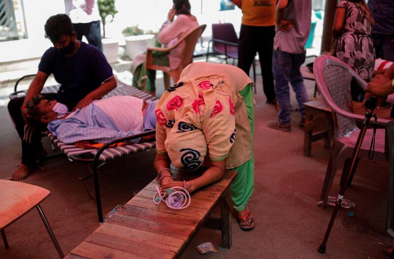 The wife of Nanhe Pal, 52, cries as she pleads for oxygen support for her husband, who is suffering from breathing problems at a Gurudwara, amid the spread of the coronavirus disease, in Ghaziabad, India. Reuters