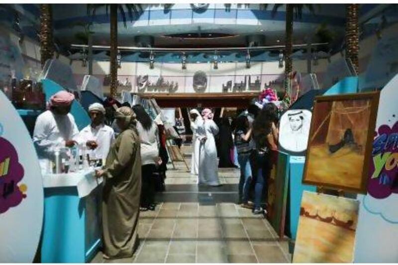 Young would-be entrepreneurs have set up stalls at Marina Mall in Abu Dhabi to sell their ideas and products.  Lee Hoagland / The National