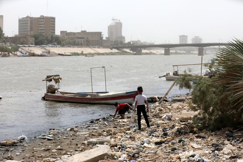 Iraqi boys play on the banks of the Tigris, which is contaminated with sewage and rubbish, in Baghdad. EPA