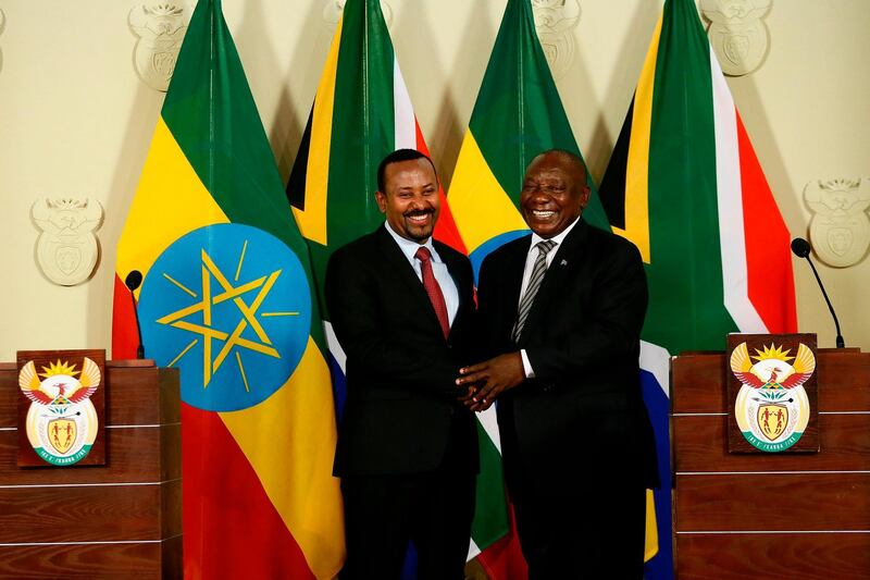 South African President Cyril Ramaphosa (R) and Prime Minister of Ethiopia Abiy Ahmed Ali (L) shake hands after concluding a press conference at the Union Buildings in Pretoria on January 12, 2020, following their meeting on matters of mutual national development, regional and continental issues as well as international developments.  / AFP / Phill Magakoe
