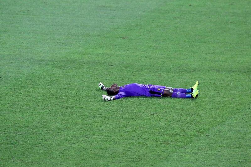 Cameroon goalkeeper Fabrice Ondoa lies on the pitch as he celebrates after Cameroon beat Egypt 2-1 in the 2017 Africa Cup of Nations final. Steve Jordan / AFP