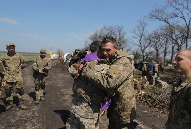 A military chaplain blesses Ukrainian soldiers on the occasion of Orthodox Easter not far from the city of Izyum in Kharkiv. EPA