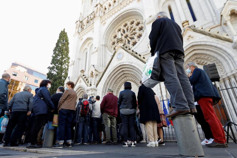 People gather in front of the Notre Dame church. Reuters