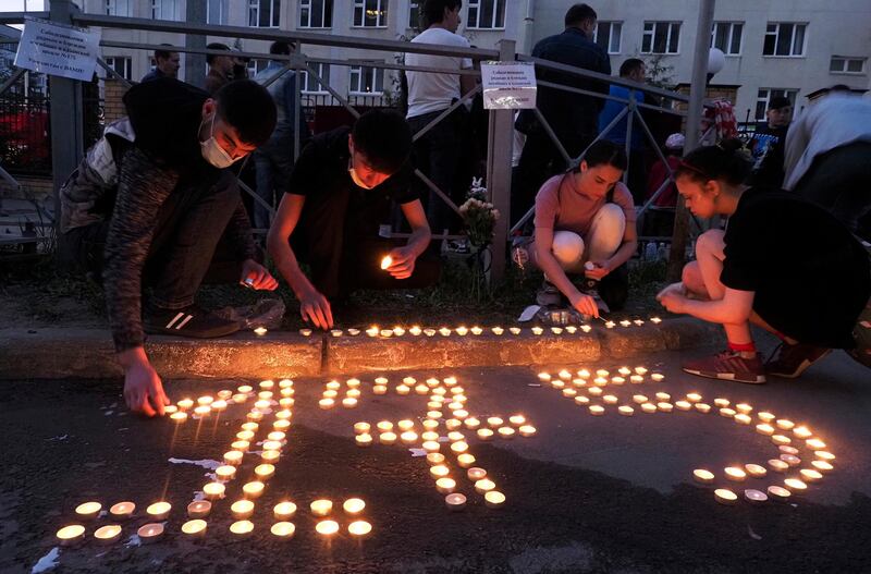 People place candles to form the number 175, after a shooting at school No 175 in the city of Kazan, in south-west Russia. Seven children and two adults were killed. A 19-year-old suspect was detained. AP Photo