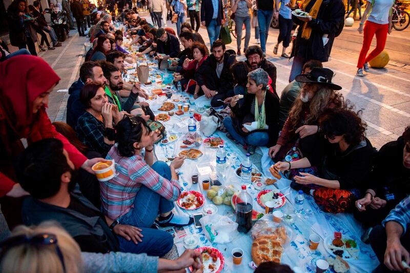 People break their fast in a street of Kadikoy district in Istanbul.  AFP