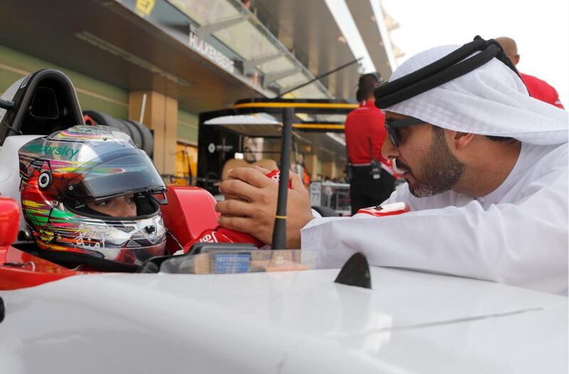 Amna Al Qubaisi, pictured speaking with her father, Khaled, before Saturday's race, experienced disappointment in Sunday's race. Victor Besa / The National