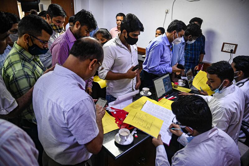 People queue up to get themselves registered for a booster dose.