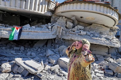 A Palestinian woman stands outside the demolished Shalabi family home.
