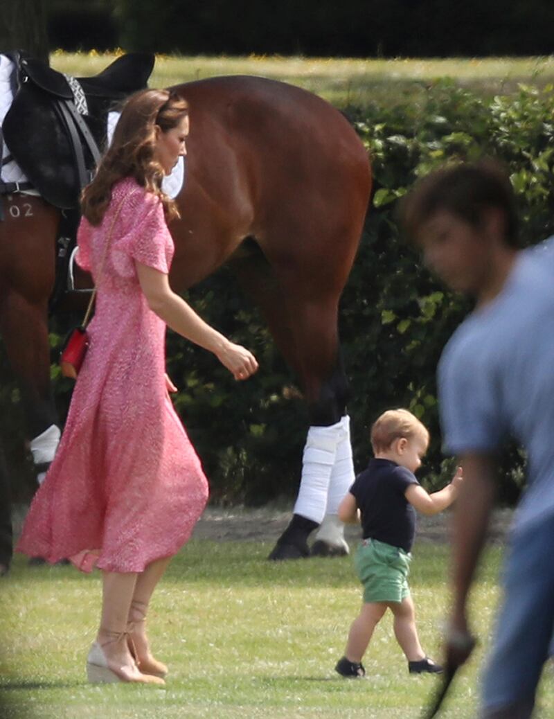 The Duchess of Cambridge runs after her son, Prince Louis. AP