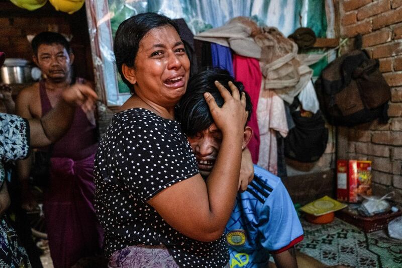 Family members cry in front of a man after he was shot dead during an anti-coup protesters crackdown in Yangon. Reuters