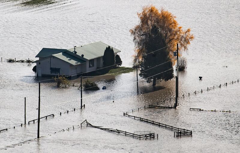 A house on a farm is surrounded by floodwaters in Abbotsford.