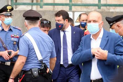 The League's leader Matteo Salvini, center wearing a face mask, leaves after a hearing in court in the Sicilian city of Catania, southern Italy, Saturday, Oct. 3, 2020. Italy's right-wing former interior minister Salvini, appeared Saturday before a court in Sicily that will decide whether he will face trial for blocking 131 migrants for several days on a coast guard ship in 2019.  (Mauro Scrobogna/LaPresse via AP)