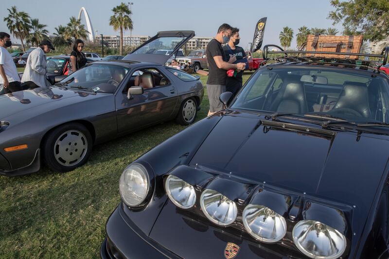 Guests admire a  Porsche at The Grand Picnic.