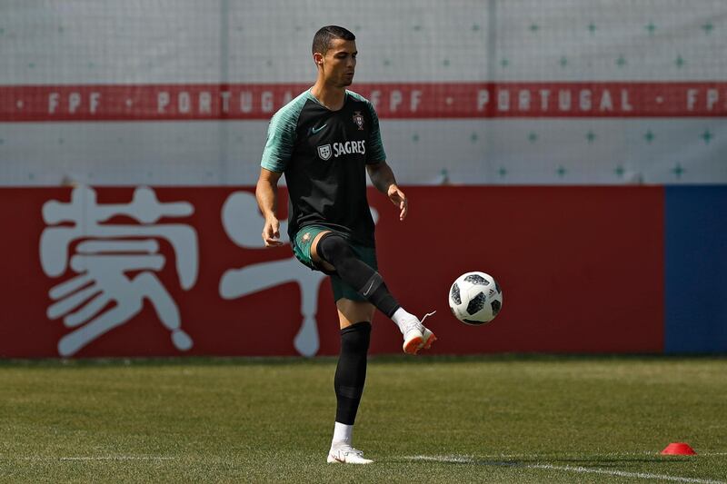 Cristiano Ronaldo plays the ball during the training session. Francisco Seco / AP Photo