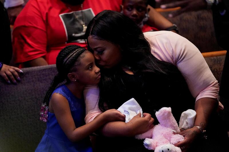 Roxie Washington holds Gianna Floyd, the daughter of George Floyd, as they attend the funeral service. Reuters