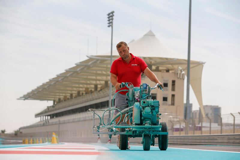 A painter lays down a fresh coat of Yas Blue on the circuit. Courtesy Yas Marina Circuit