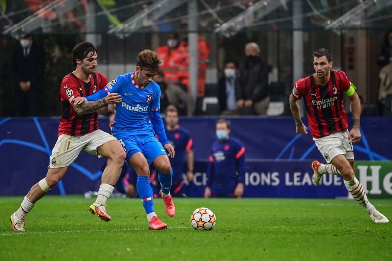 AC Milan's Italian midfielder Sandro Tonali and Atletico Madrid's French midfielder Antoine Griezmann go for the ball. AFP