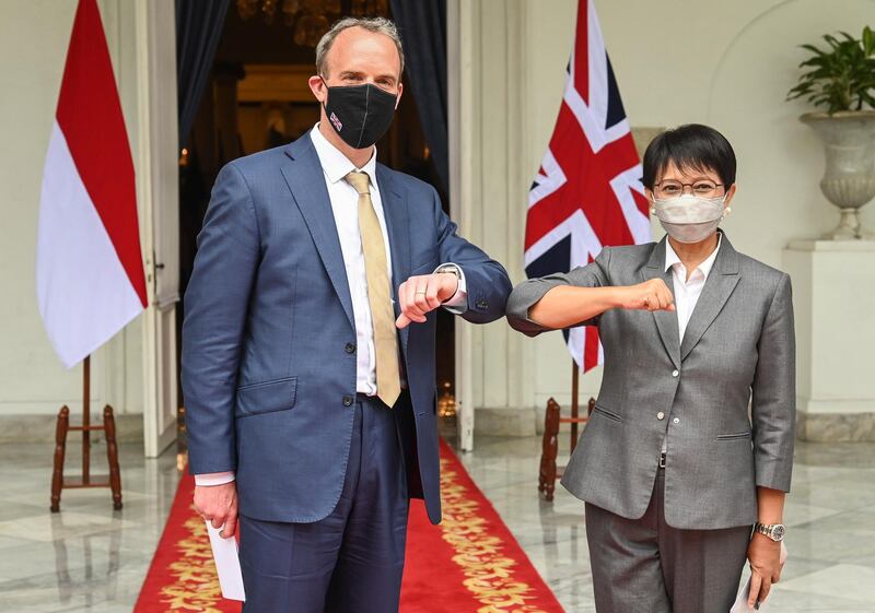 epa09119755 A handout photo made available by the Indonesian Ministry of Foreign Affairs shows Britain Foreign Secretary Dominic Raab (L) posing with his Indonesian Counterpart Retno Marsudi (R) during their meeting in Jakarta, Indonesia, 07 April 2021. Raab is on an official visit to tighten bilateral relationships between the two countries.  EPA/INDONESIAN MINISTRY OF FOREIGN AFFAIRS / HANDOUT  HANDOUT EDITORIAL USE ONLY/NO SALES